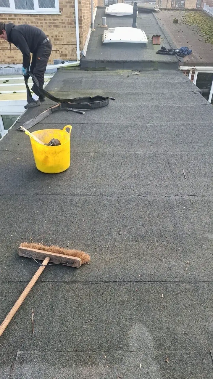 An old, failing flat felt roof being stripped back by Tammat Group