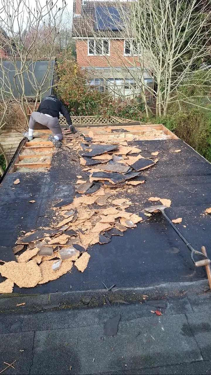 An old flat roof being stripped back to the joists by Tammat Group