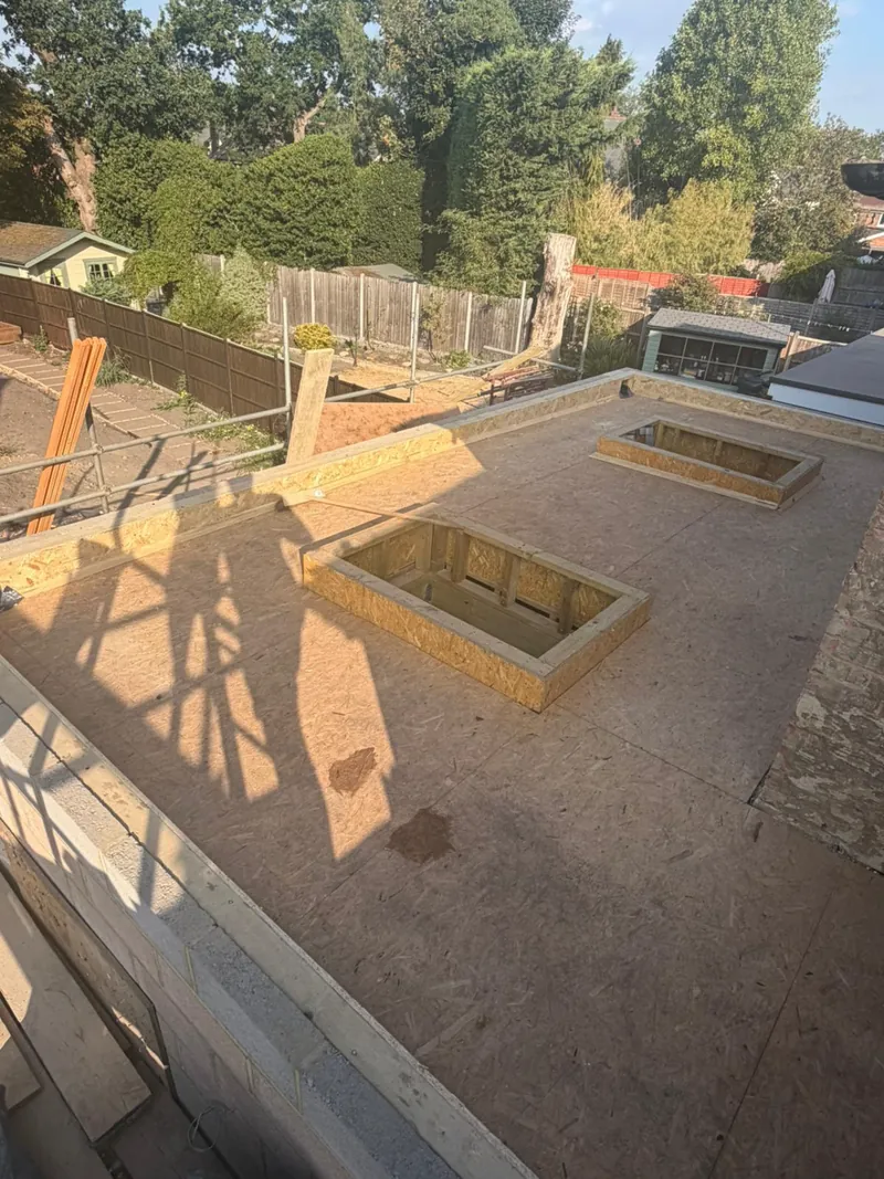 A flat roof deck with two rooflight openings framed out before the felt covering by Tammat Group