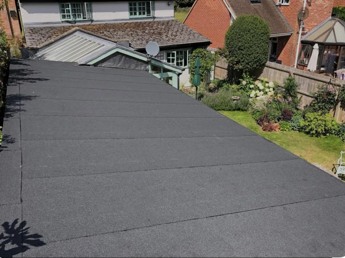 A clean, completed flat felt roof to the rear of a house