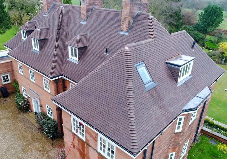 Aerial view of a large period tiled roof with dormers by Tammat Group