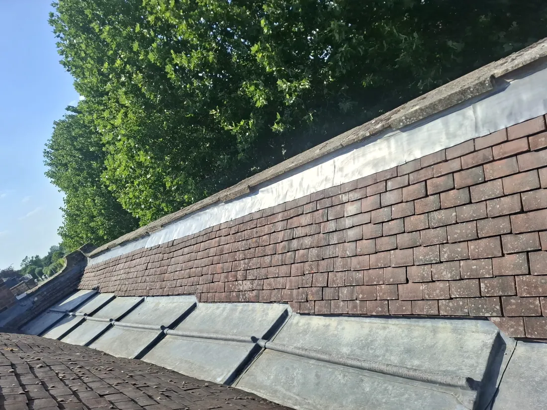 A new lead valley and flashing between tiled roof slopes by Tammat Group